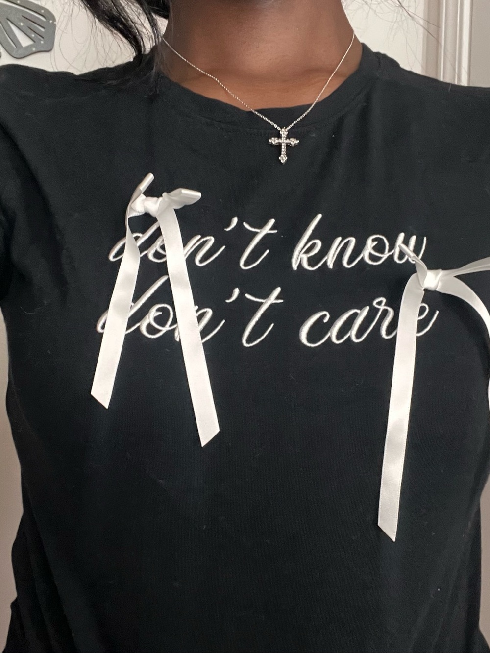 Women's Black Short-Sleeve Graphic Tee with White Ribbon Accents